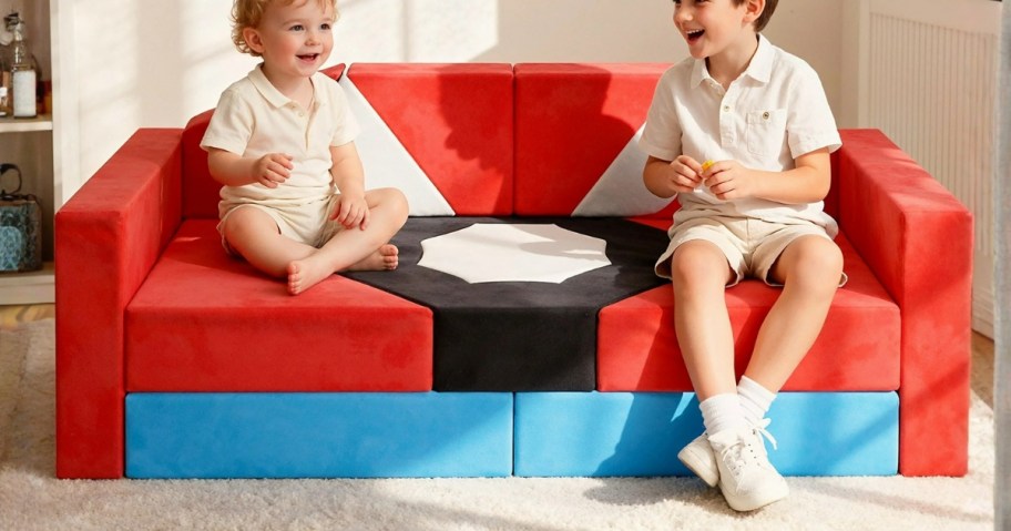 two little boys on a red, black, and white modular kids play couch