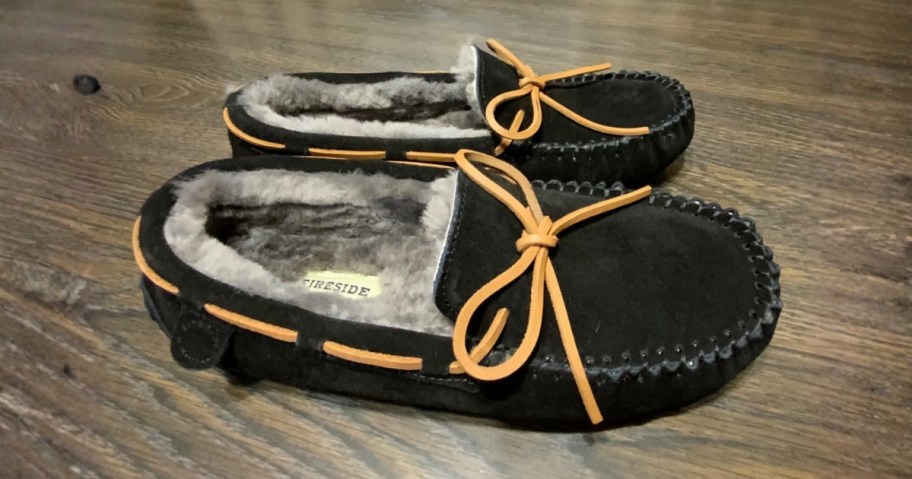 a pair of men's black Dearfoams slippers with shearling inside