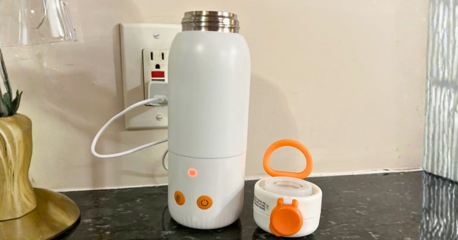 a portable baby bottle warmer plugged into a wall