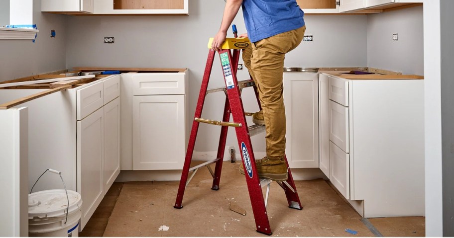 man climbing on a step ladder