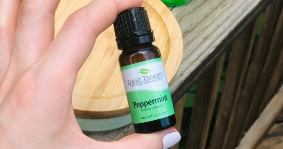 hand holding a Plant Therapy Peppermint essential oil bottle