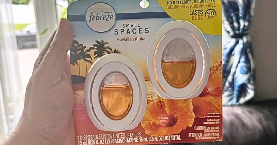 hand holding a 2-pack of Febreeze Small Spaces Air Fresheners