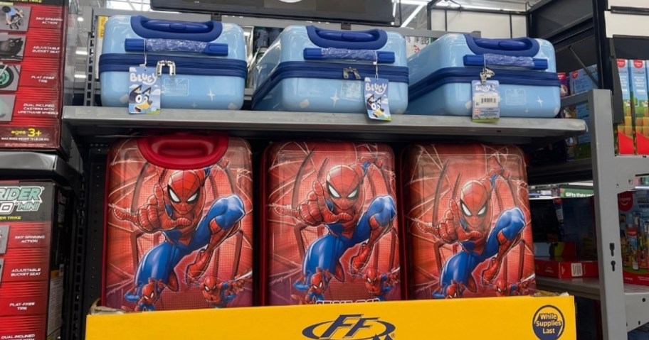 Bluey and Spiderman kids hardside luggage on a store shelf