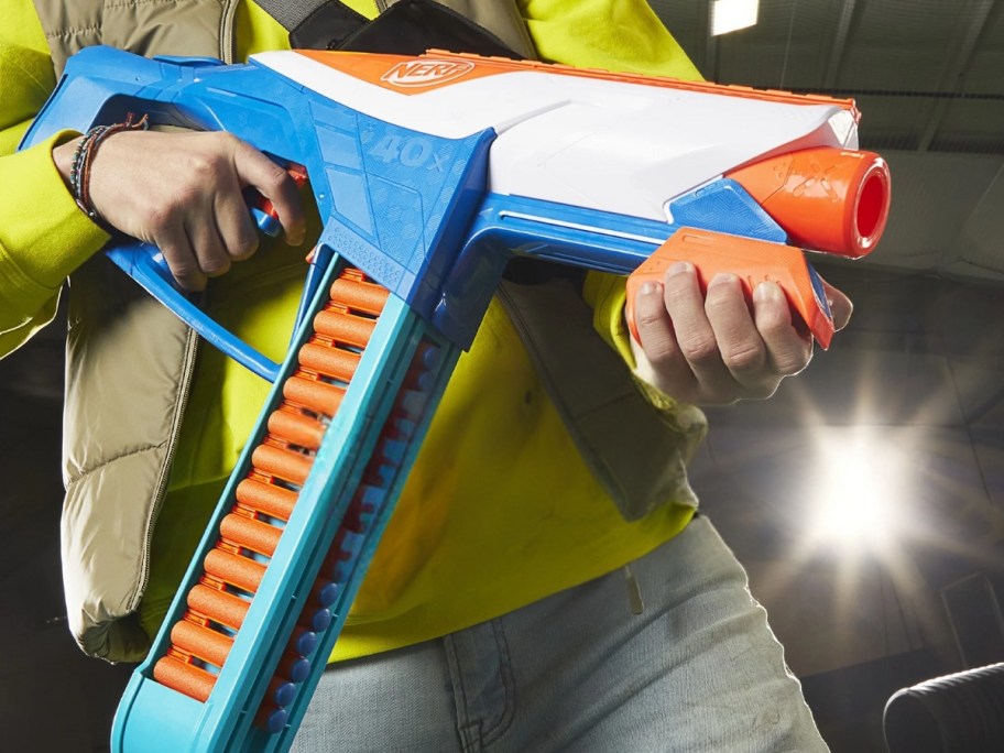 kid holding a nerf dart blaster