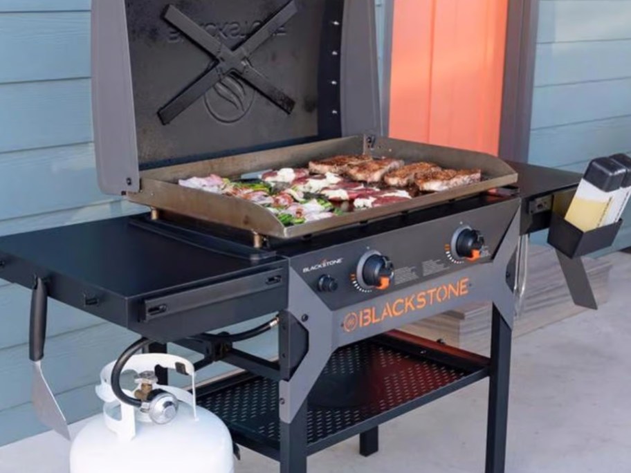 a large Blackstone griddle with food cooking on it on a patio