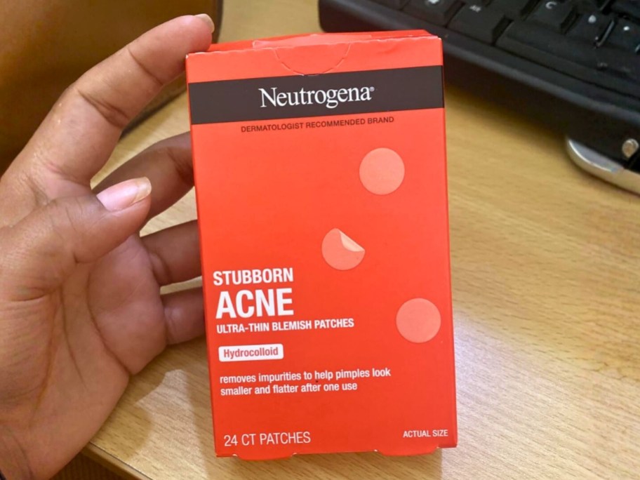 hand holding a box of Neutrogena Pimple Patches