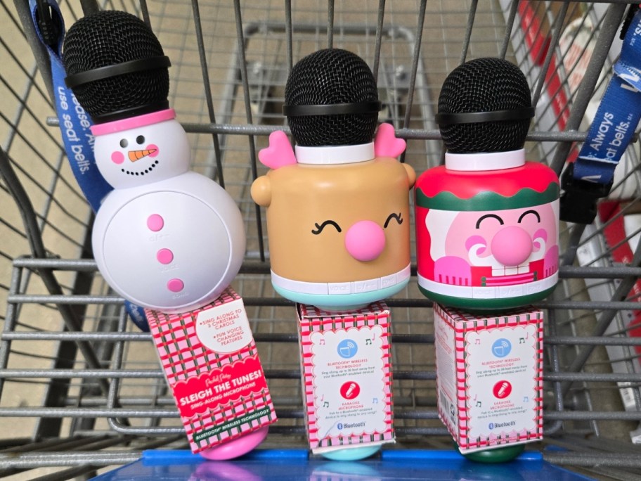 snowman, reindeer, and nutcracker kids karaoke microphones in a Walmart cart