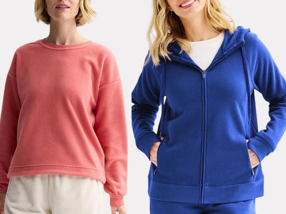 woman wearing a pink sweatshirt and woman wearing a blue zip up hoodie