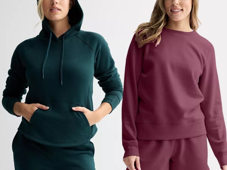 woman wearing a green hoodie and joggers and woman waring a purple sweatshirt and joggers