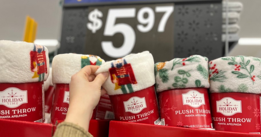 One minute grabbing holiday themed blanket from Walmart store shelf