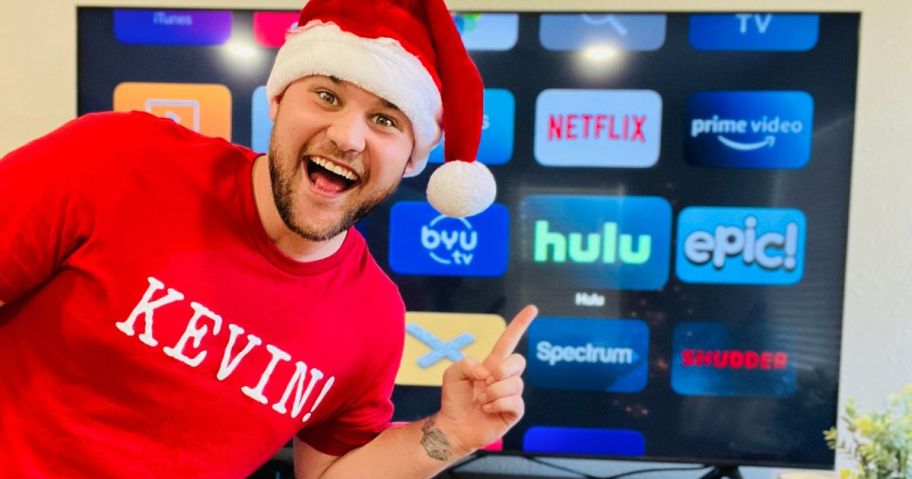 Man in a santa hat pointing at Hulu on a streaming homescreen
