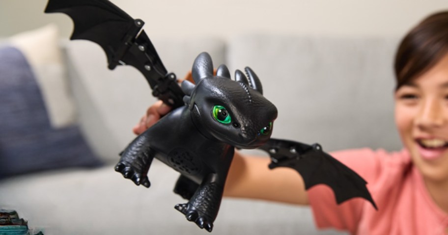 boy playing with how to train your dragon toothless interactive dragon toy