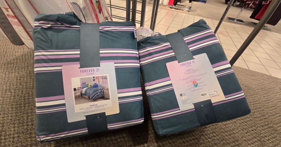 2 packages of beggins on the floor of a store