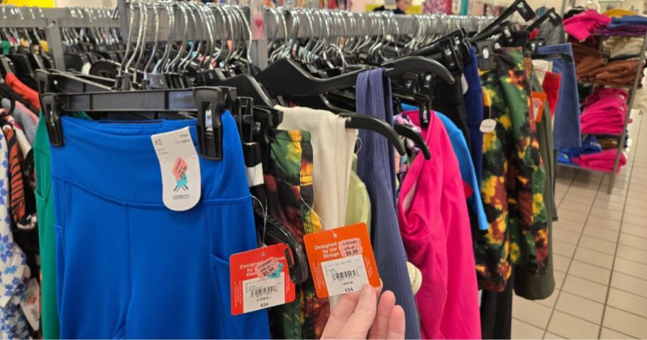 Several clothing items on a rack in a store