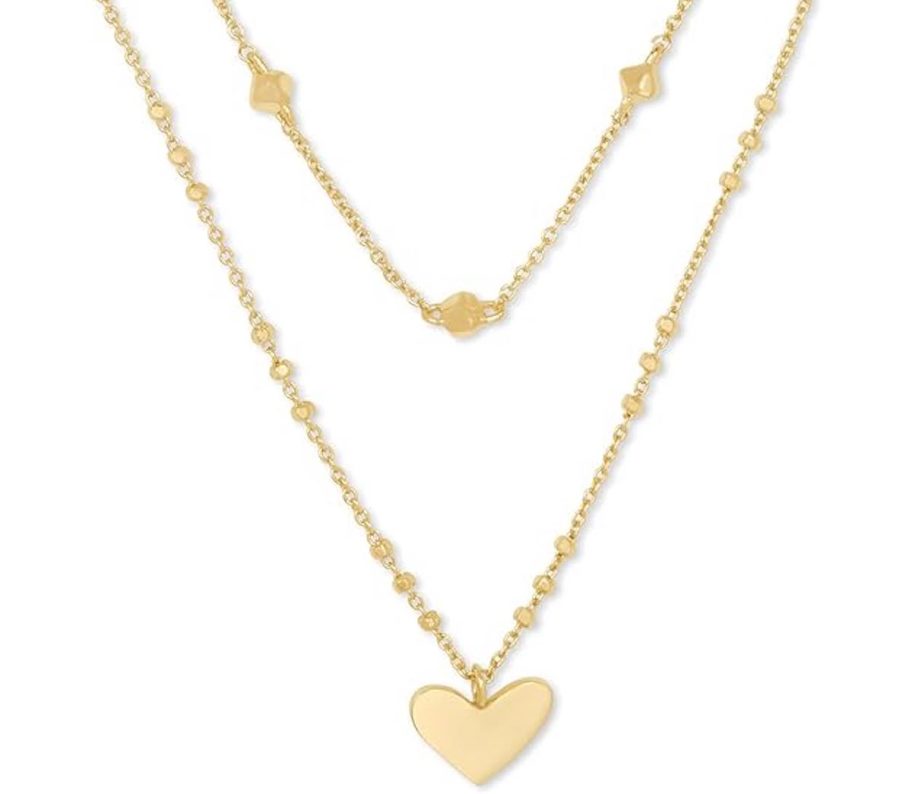 gold heart necklace on white background