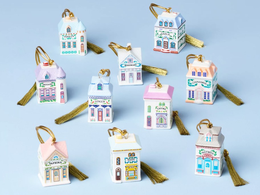 various Lenox Spice Village Ornaments on a blue background