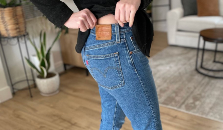 Women wearing Levi's jeans and standing in living room