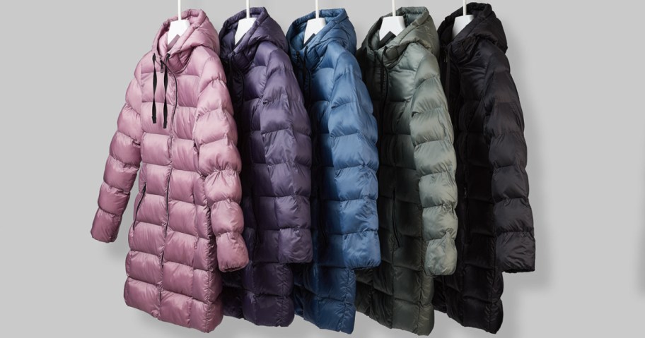 32 degrees long puffer jackets in different colors hanging on rod with white hangers