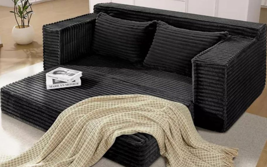 Macys couch with blanket on it