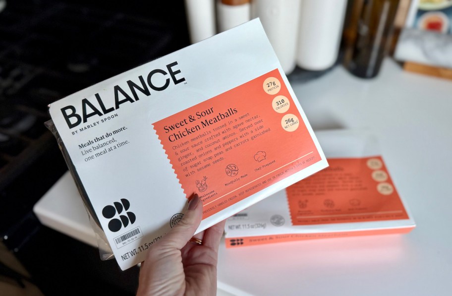 hand holding balance frozen meal