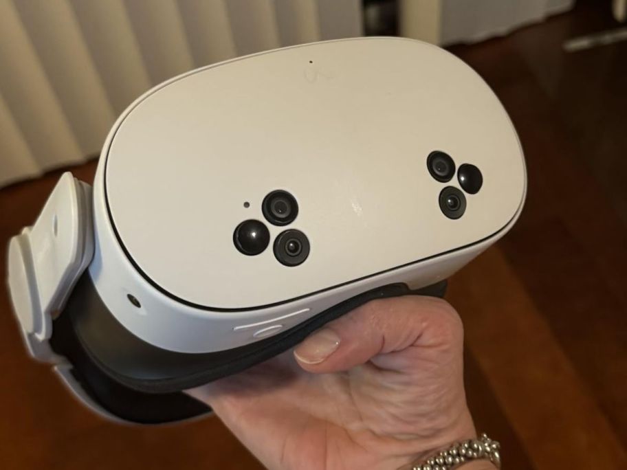 Hand holding a Meta Quest VR Headset