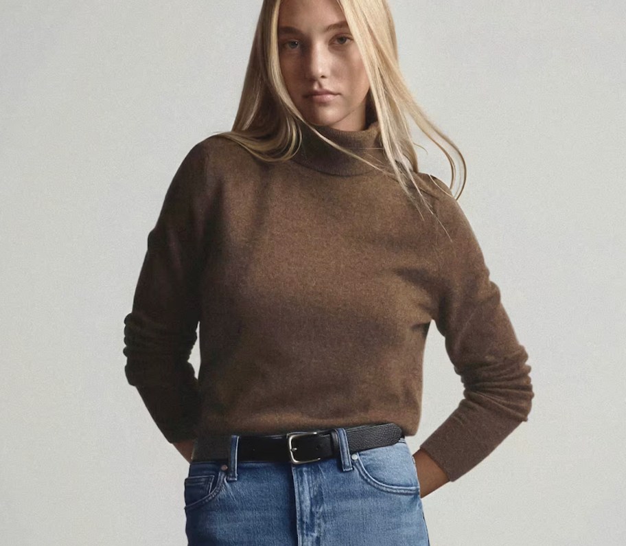woman modeling a brown turtleneck sweater