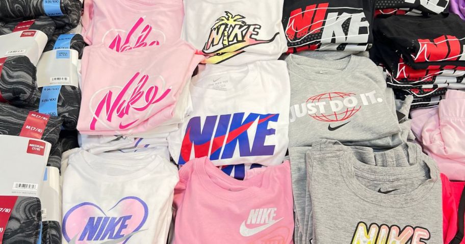 A table of folded nike kids t-shirts