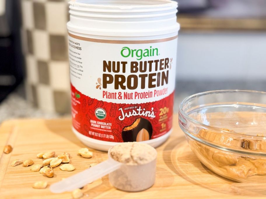 An open tub of Orgain Justin's Peanut butter Protein Powder