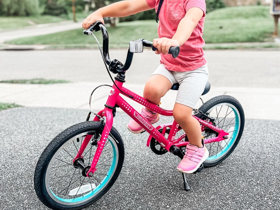Little girl on pink guardian bike