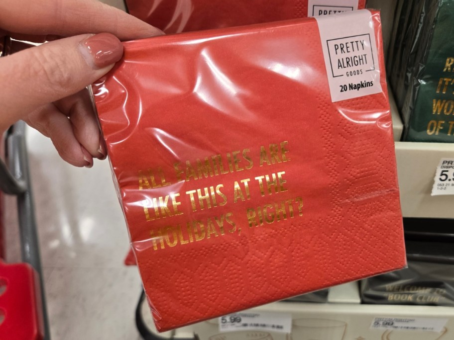 hand holding a pack of napkins that says 'All Families Are Like This At The Holidays, Right?'