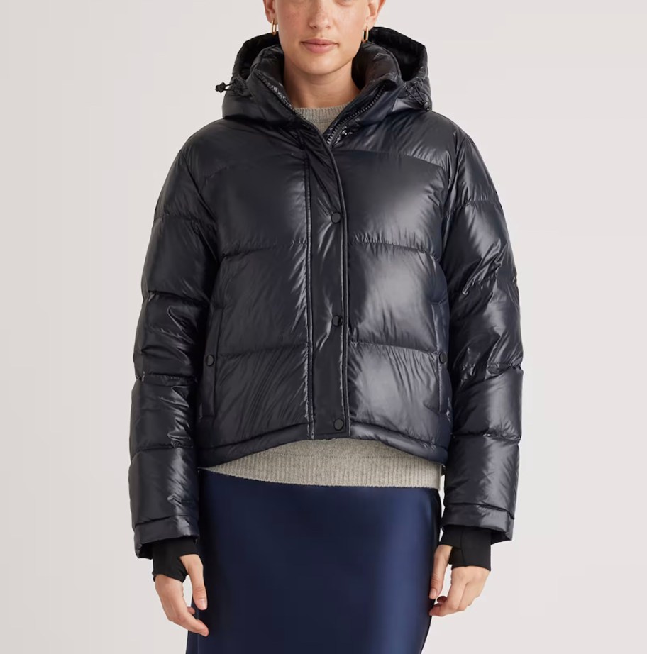 woman modeling black puffer jacket