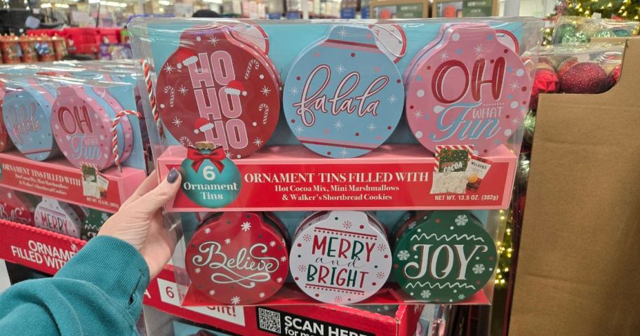Several tins in the shape of ornaments in a store
