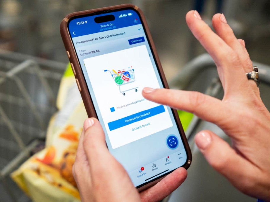 person completing scan & go transaction on phone