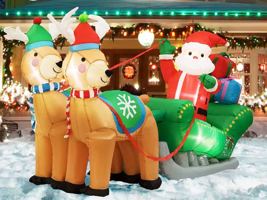 large santa and reindeer inflatable in front yard