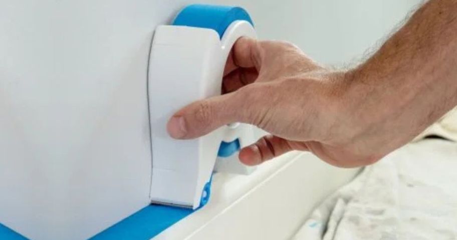 A Scotch Painters Tape Applicator being used on trim