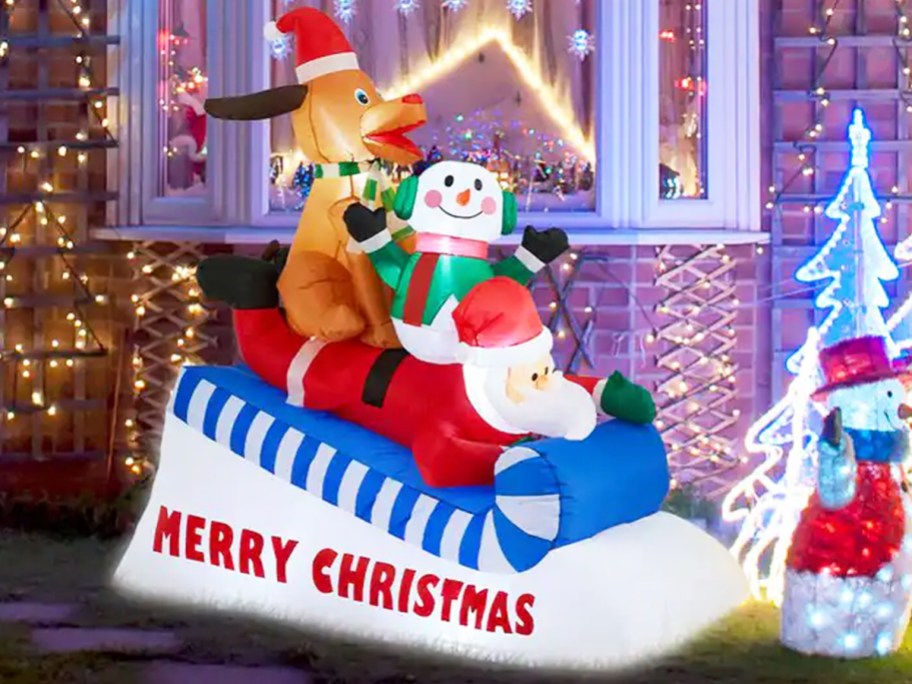 Santa, Snowman, and Dog on sled inflatable in front yard