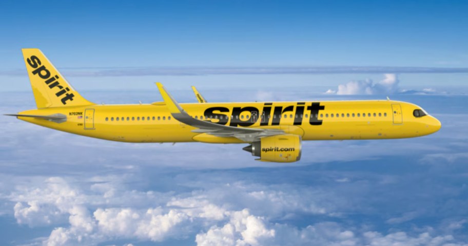 yellow Spirit Airlines flight in sky