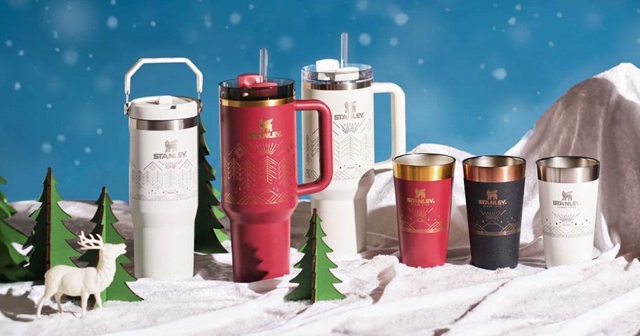 Stanley bottles, tumblers, and cups with gold designs on them