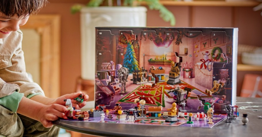 Child playing with opened Star Wars Advent Calendar.