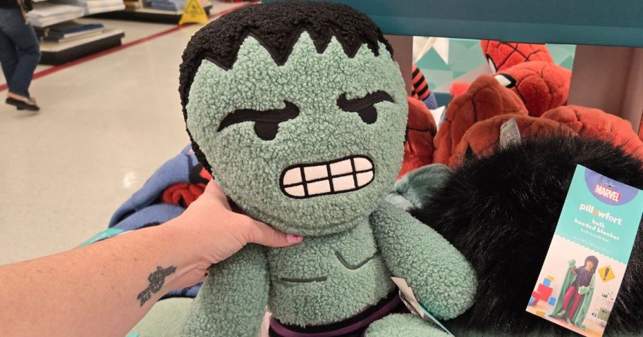 Hand holding a Pillowfort Hulk Pillow Buddy