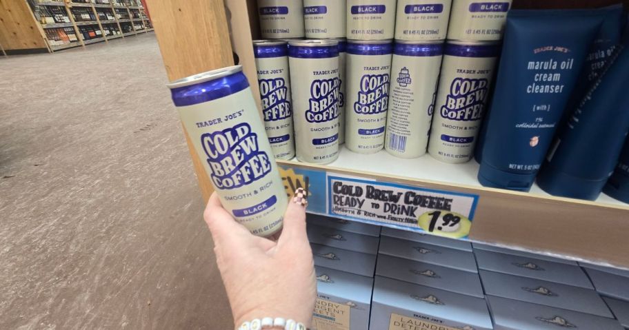 a person holding a can of cold brew coffee