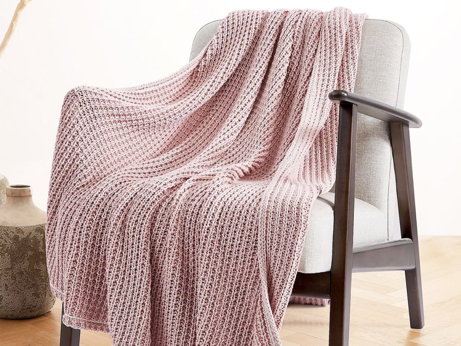 light pink waffle throw blanket draped over an accent chair