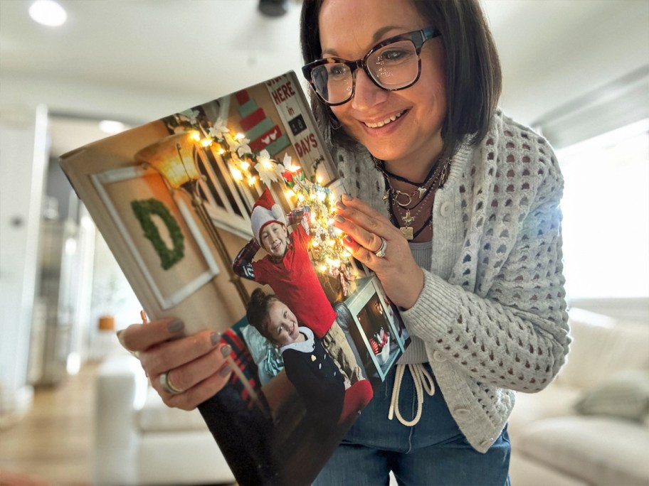 woman holding a lighted christmas photo canvas