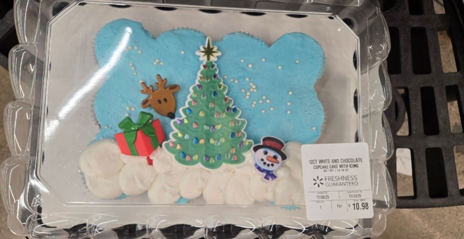 a blue and white Cupcake Cake with Christmas themes on it
