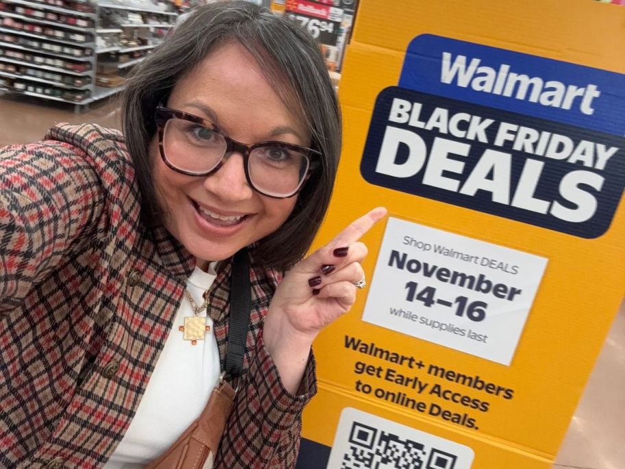 Woman pointing to a Walmart Black Friday Sign on Display at a store