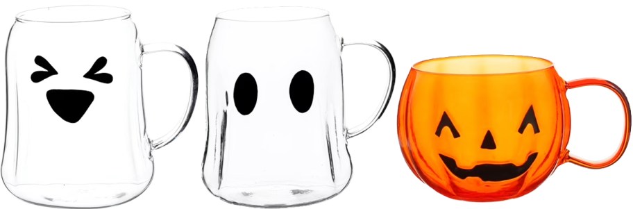 two glass ghost mugs and an orange pumpkin mug