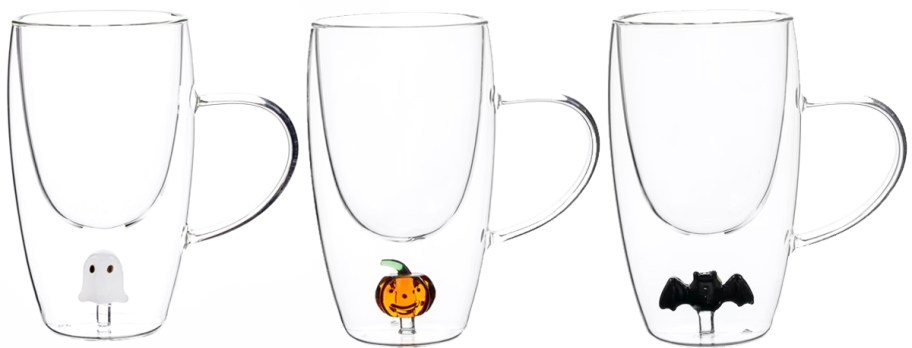 three glass coffee mugs with a ghost, pumpkin, and bat at the bottom