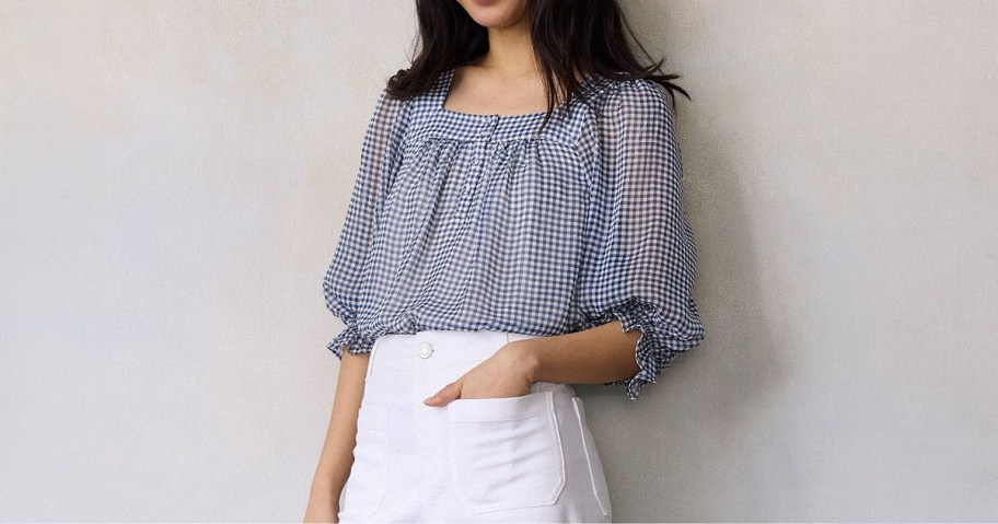 Woman wearing LC Lauren Conrad 3:4 Length Sleeve Henley Peasant Blouse and jeans