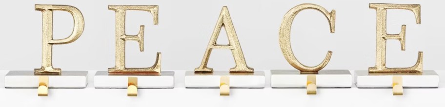 gold stocking holders that spell out "peace"