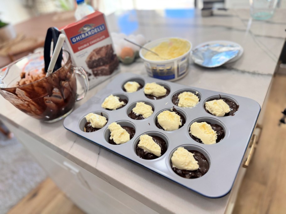adding cream cheese filling on top of a brookie 